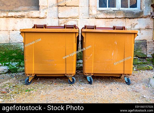 Two Big Brown Dumpster Recycling Bins at Street