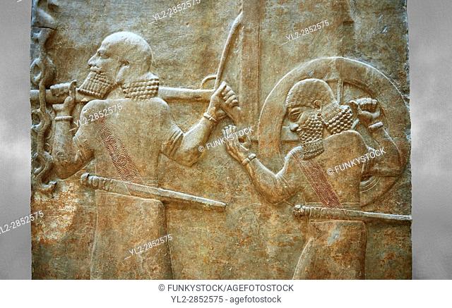 Stone relief sculptured panel of soldiers carrying a war chariot . Facade L. Inv AO 19884 from Dur Sharrukin the palace of Assyrian king Sargon II at Khorsabad