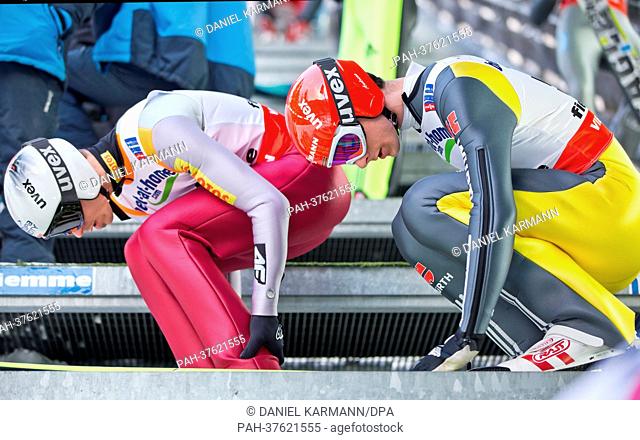 Andreas Wank (R) of Germany prepares for his jump during a training session of the men large hill individual ski jumping at the Nordic Skiing World...