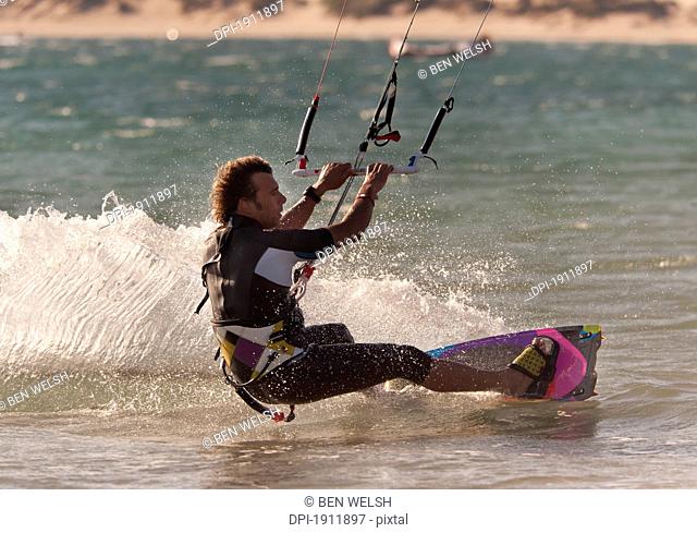 a man kitesurfing, tarifa, cadiz, andalusia, spain