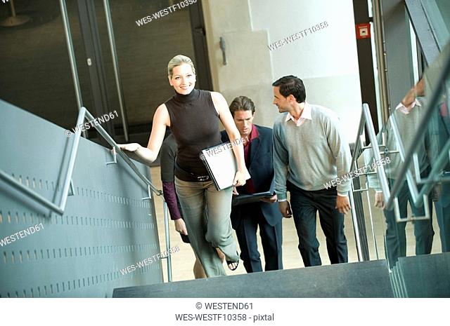 Germany, business people climbing stairs