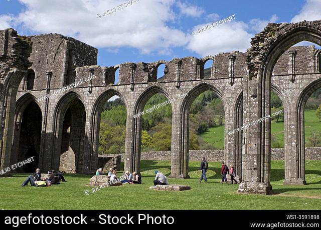 Visitors at the site of medieval Llanthony Abbey, of the Cistercian order of monks, at the Brecon Beacons National Park, Wales, UK