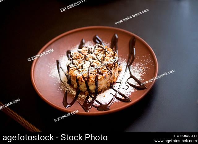 Picture of vegan dish represented on wooden plate. Sweet meal is being served in vegan restaurant or cafe. Healthy food