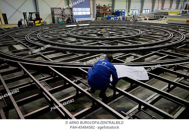 An employee of the stagecraft company SBS Buehnentechnik GmbH works on a revolving stage for a theatre in Surgut, Russia, at the factory grounds in Dresden