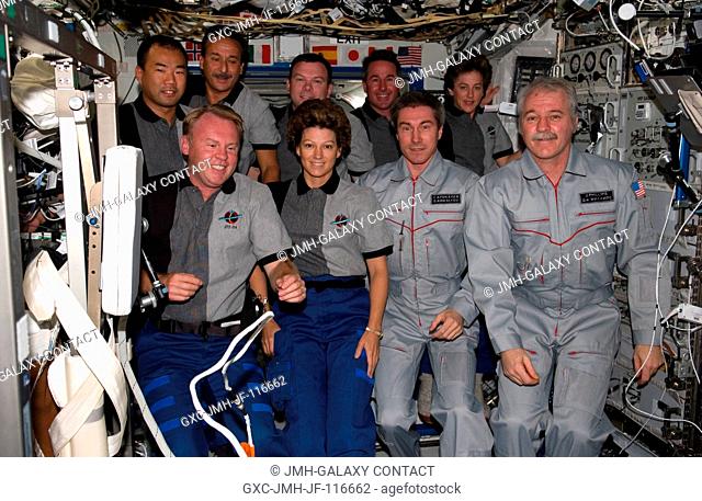 The STS-114 and Expedition 11 crewmembers gather for a group photo in the Destiny laboratory of the International Space Station