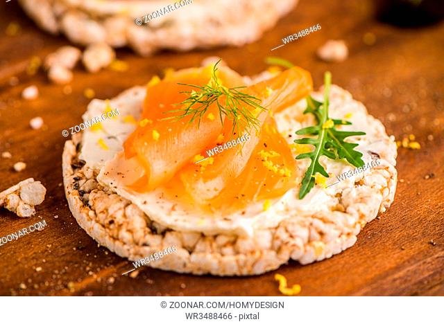 Delicious smoked salmon and cream cheese on rice bread toasts