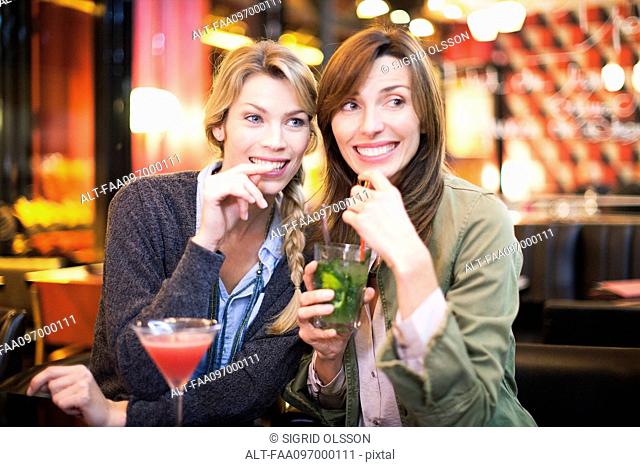 Women having cocktail in bar