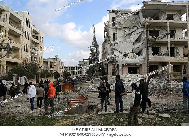 dpatop - 18 February 2019, Syria, Idlib: Syrians inspect the damage after two bomb blasts in central Idlib. At least 13 people were killed and other 25 people...