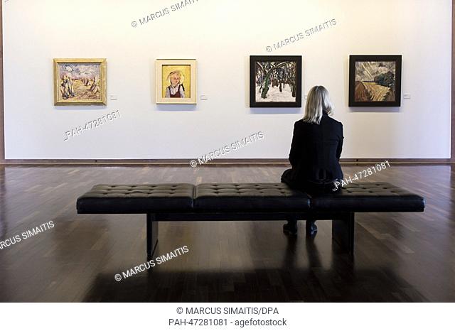 A woman sits in front of paintings in Kunsthalle Bielefeld in Bielefeld,  Germany, 20 March 2014. The exhibition ""Das Glueck der Kunst. (lit