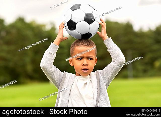 little boy with soccer ball at park