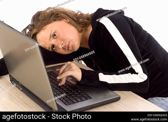 isolated on white bored/tired female teenager at the laptop