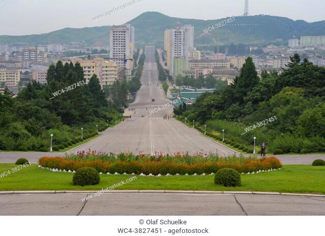 Kaesong, North Korea, Asia - Looking from the sqaure adjacent to the History Museum Kaesong at the cityscape that shows an everyday scene with pedestrians on an...
