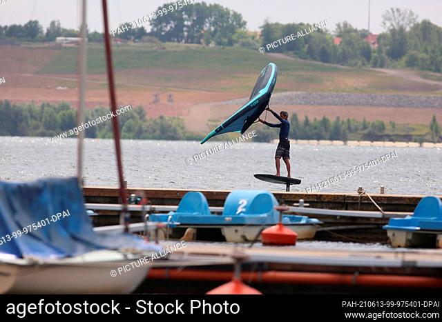 13 June 2021, Saxony-Anhalt, Schadeleben: Water sports enthusiasts are out and about on Lake Concordia. After several opening steps in the context of falling...