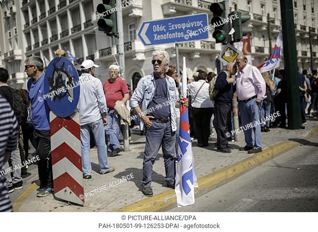 01 May 2018, Greece, Athens: Members of the pro-communist union PAME take part in a May Day rally outside the Greek Parliament