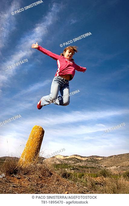 Girl jumping in the blue sky