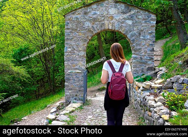 Young backpacker under an archway door