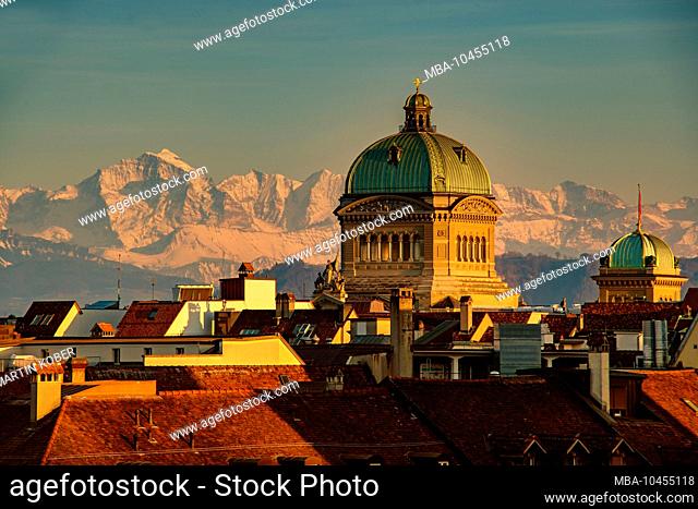 The Bundehaus towers majestically over the historic old town of Bern. The Jungfraus massif shines in the background