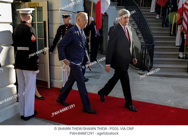 US Vice President Joseph Biden (L) and US Secretary of State John Kerry (R) walk out of the White House to participate in an official arrival ceremony for...