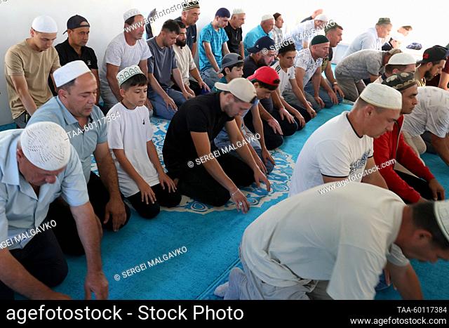 RUSSIA, REPUBLIC OF CRIMEA - JUNE 28, 2023: Muslims pray in Yan'y Jami Mosque in the town of Saki during Eid al-Adha (or Kurban Bairam