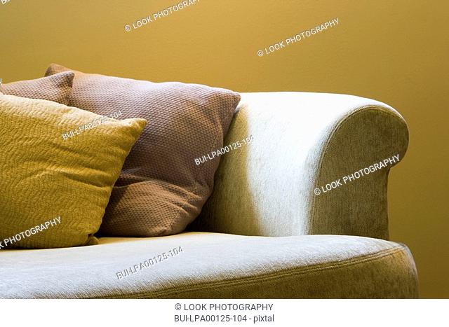 Detail of a sofa bed with throw pillows