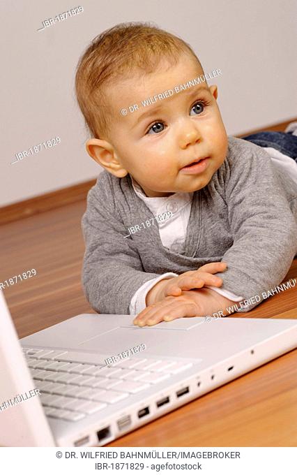 6-month-old infant with laptop