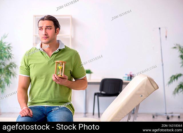 Young man waiting for the doctor in the clinic