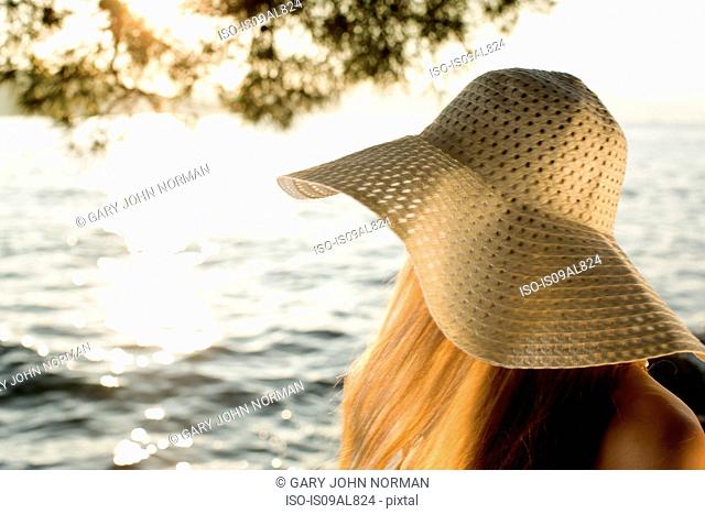 Young woman in sunhat at coast, Milna, Brac, Croatia