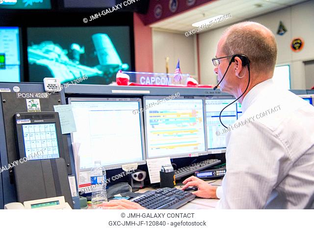 A scene inside the space station flight control room (FCR-1) in the Johnson Space Center's Mission Control Center, features Robert Hanley seated at the...
