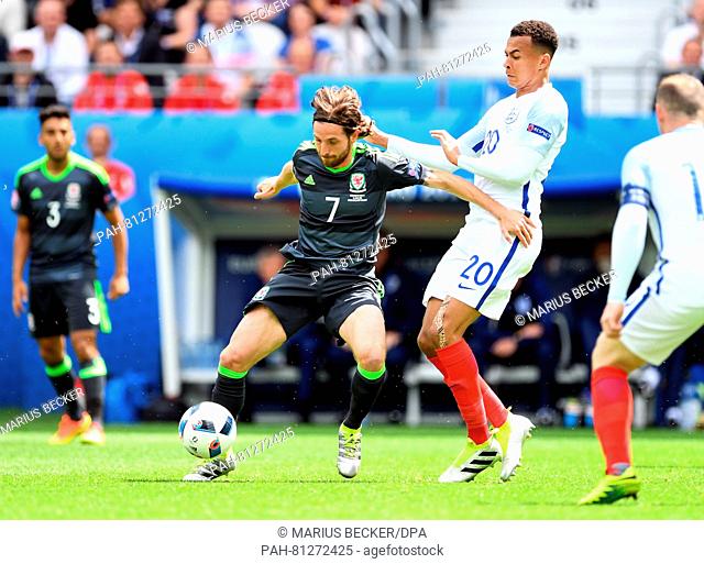 Dele Alli (2R) of England and Joe Allen (2L) of Wales challenge for the ball during the Euro 2016 Group B soccer match between England and Wales at the Stade...