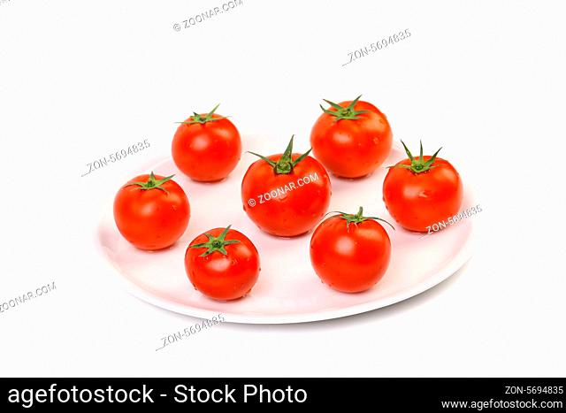 Fresh ripe cherry tomatoes on a white plant. Close up