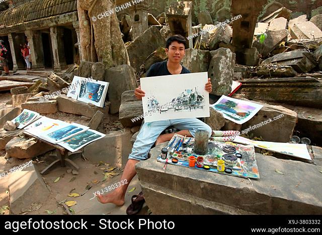 A boy sketches the architectura of angkor temple, Ta Prohm, Angkor, Cambodia