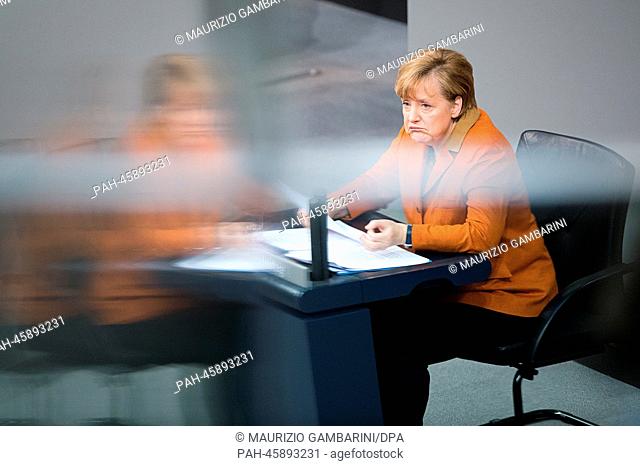 German Chancellor Angela Merkel makes a statement to the German Parliament in Berlin,  Germany, 29 January 2014. She was seated due to a skiing accident