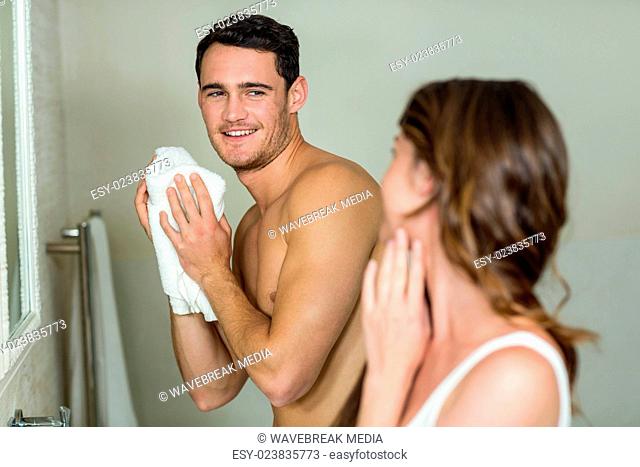 Couple in front of bathroom mirror