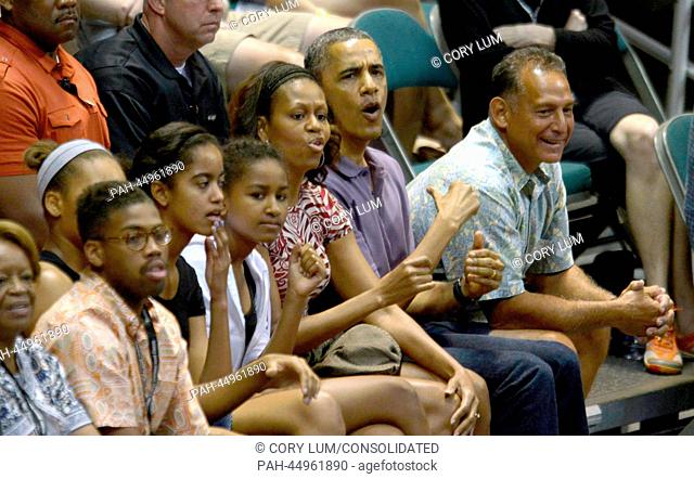 President Barack Obama reacts to a play as he, first lady Michelle Obama and daughters Malia Obama and Sasha Obama attend the Hawaiian Airlines Diamond Head...