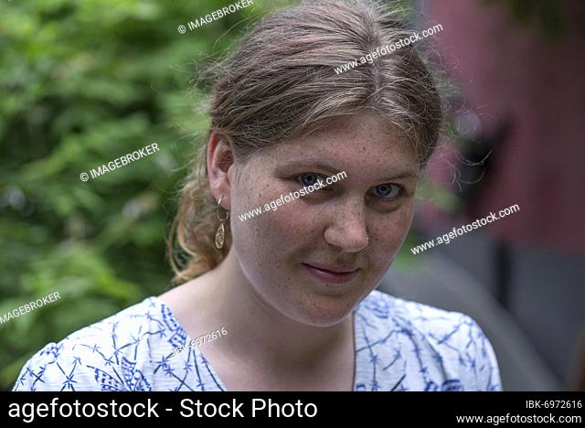 Portrait of a young woman with freckles, Germany, Europe