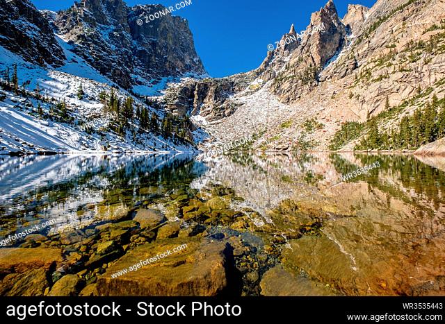 Emerald Lake and reflection with rocks and mountains in snow around at autumn. Rocky Mountain National Park in Colorado, USA
