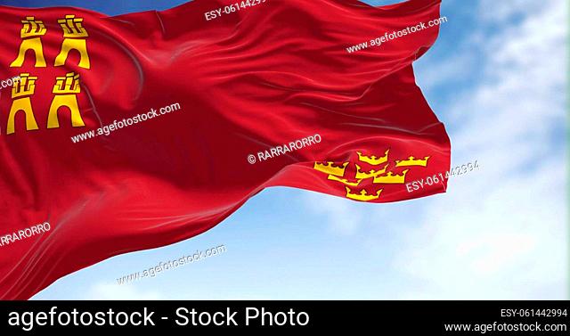 The Region of Murcia flag waving in the wind on a clear day. Region of Murcia is an autonomous community of Spain located in the southeast part of the Iberian...