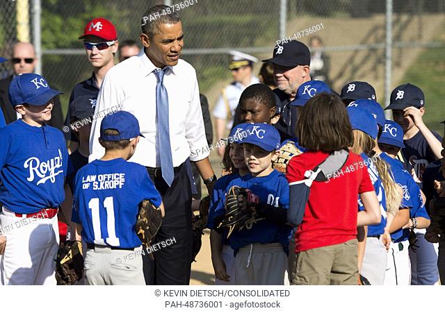 United States President Barack Obama greets players as he visits a little league game at the Friendship Park in Washington, D.C. on May 19, 2014