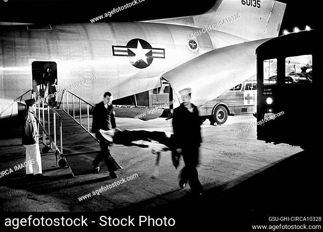 Military Staff carrying wounded Serviceman on Stretcher from Airplane after arriving from Vietnam, Andrews Air Force Base, Maryland, USA, Warren K