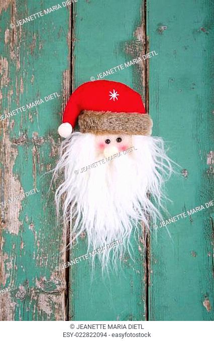 Close up of Santa head on wooden background for christmas