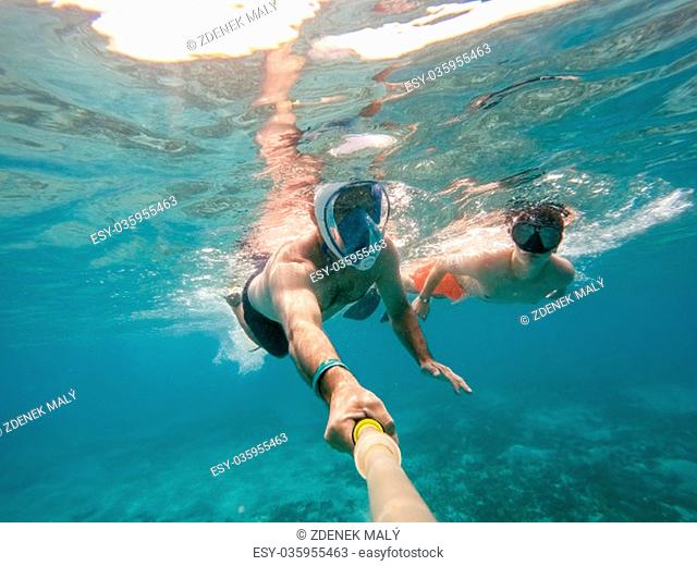 father and son snorkel in underwater exotic tropics paradise with fish and coral reef, beautiful view of tropical sea. Marsa alam, Egypt
