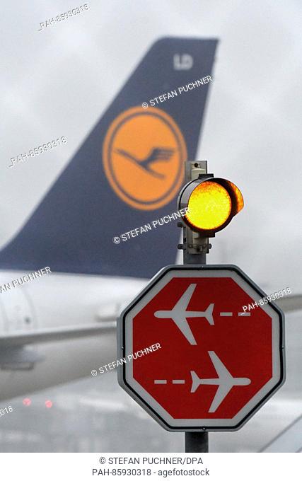 A stop sign can be seen in front of a Lufthansa airplane in the maneuvering area at the airport in Munich,  Germany, 24 November 2016
