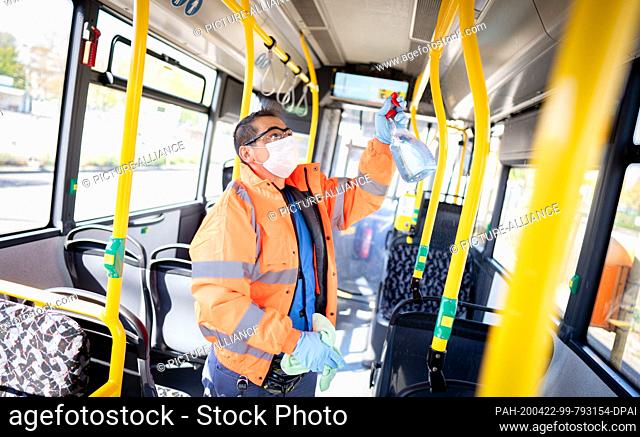 22 April 2020, Berlin: An employee cleans the passenger area of a BVG bus at the terminal stop Kurt-Schumacher-Platz. Teams of two to three employees clean up...
