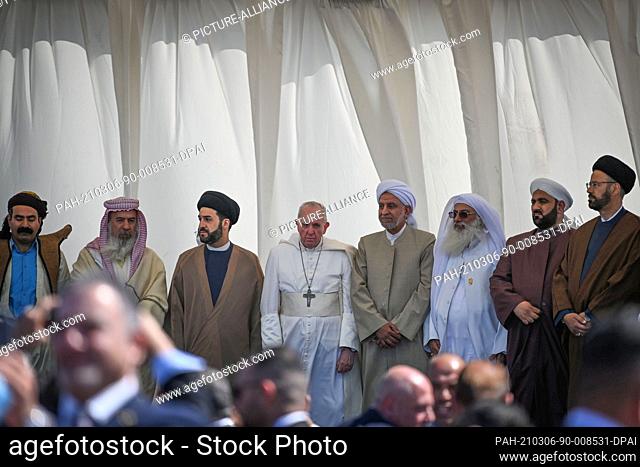 06 March 2021, Iraq, Nasiriyah: Pope Francis is surrounded by religious figures from different Iraqi sects as he attends an interreligious meeting in the...