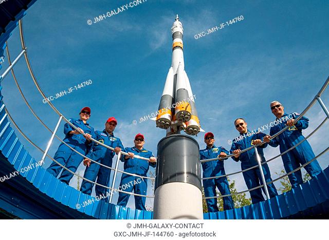 At the Cosmonaut Hotel crew quarters in Baikonur, Kazakhstan, the Expedition 53-54 prime and backup crewmembers pose for photos around a Soyuz rocket mock up...