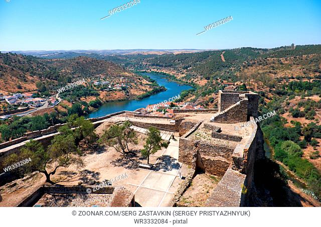 The view from the Keep tower of Mertola Castle into the inner castle courtyard and the surrounding hills and Guadiana river. Mertola. Portugal