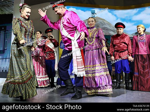 RUSSIA, MOSCOW - DECEMBER 12, 2023: People dance at a Don Cossack wedding during the Russia Expo international exhibition and forum at the VDNKh exhibition...