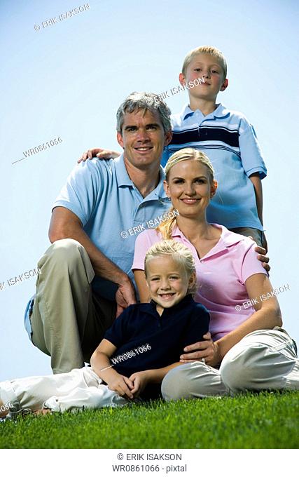 Low angle view of a family sitting on grass
