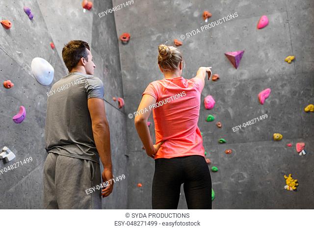 man and woman exercising at indoor climbing gym