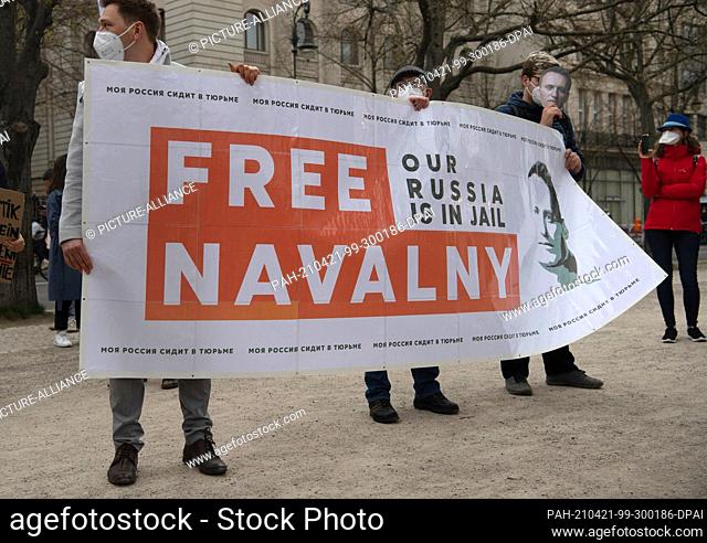 21 April 2021, Berlin: Demonstrators stand in front of the Russian embassy on the street Unter den Linden. With posters and on banners they demanded the release...
